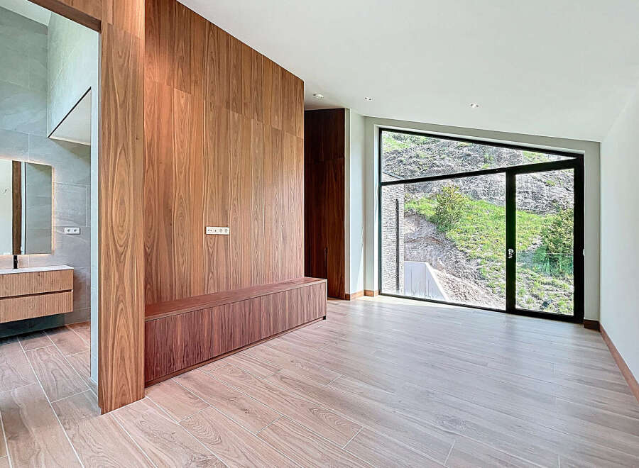 This property boasts a seamless blend of modern design and natural beauty, featuring elegant wood paneling, sleek cabinetry, and expansive windows that offer breathtaking views of the outdoors.
