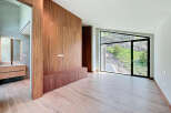 This property boasts a seamless blend of modern design and natural beauty, featuring elegant wood paneling, sleek cabinetry, and expansive windows that offer breathtaking views of the outdoors.