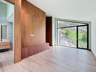 This property boasts a seamless blend of modern design and natural beauty, featuring elegant wood paneling, sleek cabinetry, and expansive windows that offer breathtaking views of the outdoors.