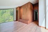 This modern living space features stunning wood paneling and flooring, creating a warm and inviting atmosphere.