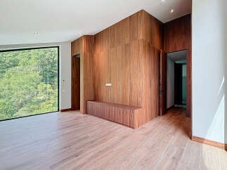 This modern living space features stunning wood paneling and flooring, creating a warm and inviting atmosphere.