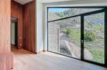 Luxury home interior showcasing sleek wooden cabinetry and light wood flooring.