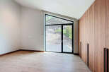 This room boasts a unique architectural window offering natural light and views of the outdoors.