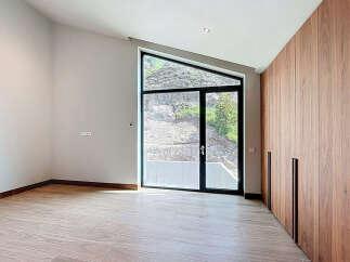 This room boasts a unique architectural window offering natural light and views of the outdoors.