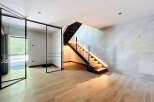 This modern home features a stunning staircase with integrated LED lighting, creating a warm and inviting ambiance.