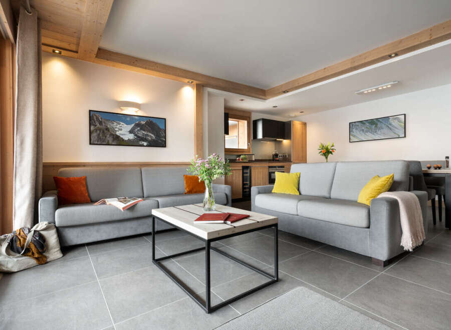 This inviting living room features two comfortable gray sofas, a modern coffee table, and stylish décor.