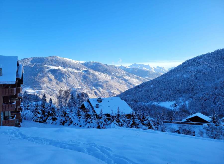 A charming ski chalet nestled in a snow-covered alpine landscape, perfect for winter getaways.