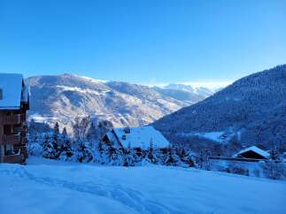 A charming ski chalet nestled in a snow-covered alpine landscape, perfect for winter getaways.