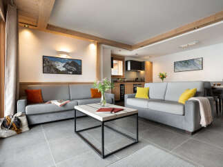 This inviting living room features two comfortable gray sofas, a modern coffee table, and stylish décor.