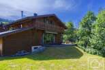 This is a charming wooden chalet boasting a spacious balcony and outdoor terrace, perfect for enjoying the surrounding greenery.