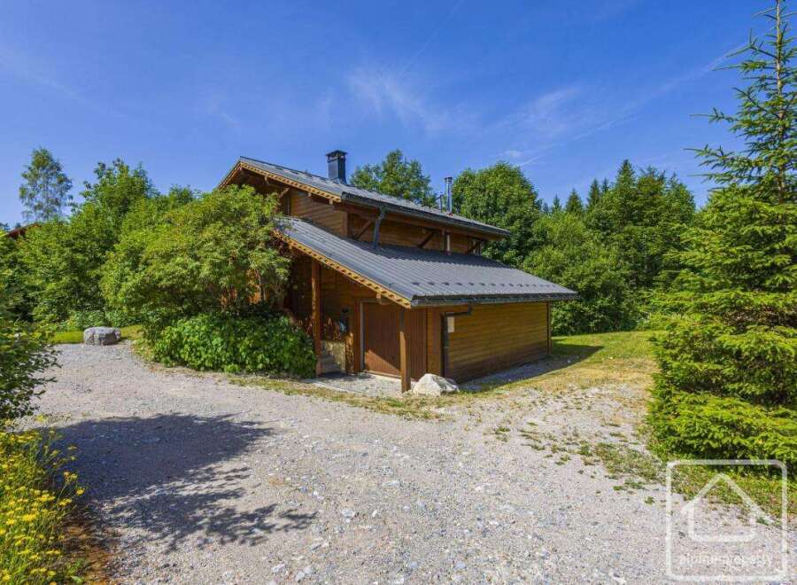 Discover this charming mountain chalet nestled among lush greenery, offering a serene retreat.