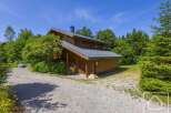 Discover this charming mountain chalet nestled among lush greenery, offering a serene retreat.