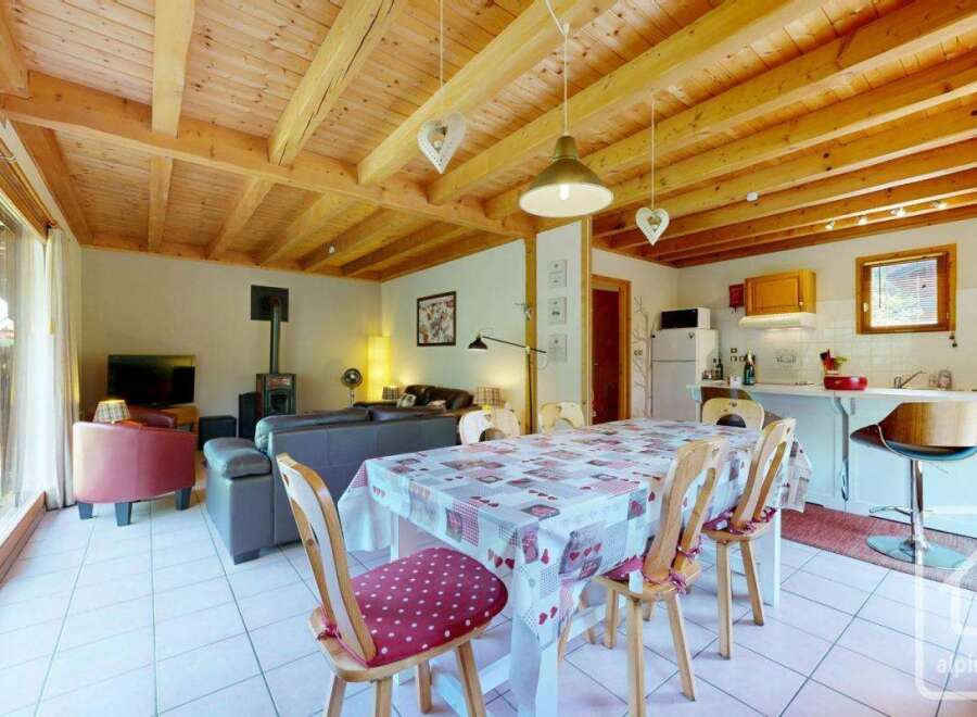 This inviting chalet features a spacious open-plan living and dining area, perfect for family gatherings.