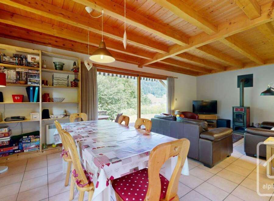 This inviting chalet features a spacious open-plan living and dining area, perfect for family gatherings.