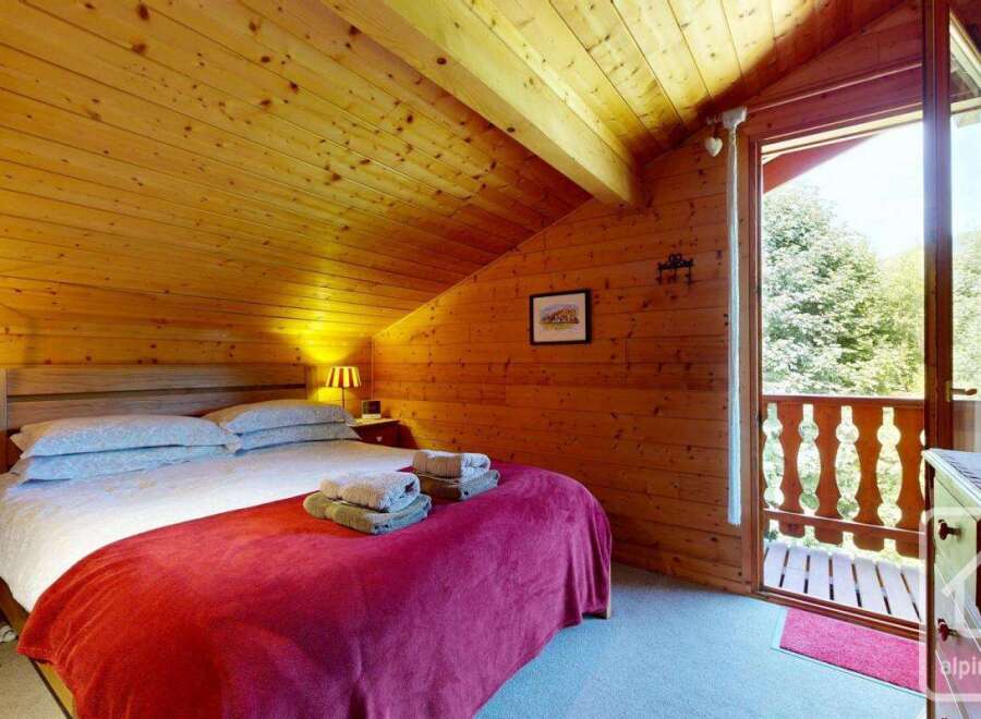 Escape to this cozy retreat featuring warm wood-paneled walls and ceilings, creating an inviting ambiance.