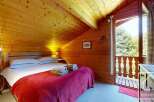 Escape to this cozy retreat featuring warm wood-paneled walls and ceilings, creating an inviting ambiance.