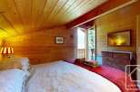 Experience the cozy charm of this alpine bedroom, featuring wood-paneled walls and ceiling that create a warm and inviting atmosphere.