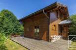 Discover this charming wooden chalet featuring a spacious deck perfect for relaxation and enjoying the outdoors.