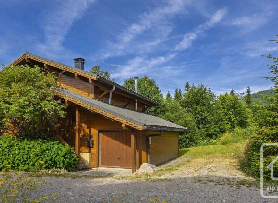 Discover this charming alpine property nestled amidst lush greenery.