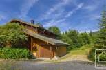 Discover this charming alpine property nestled amidst lush greenery.