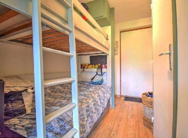 This cozy bedroom features built-in bunk beds, perfect for maximizing space in a vacation rental or family home.