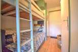This cozy bedroom features built-in bunk beds, perfect for maximizing space in a vacation rental or family home.