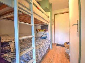 This cozy bedroom features built-in bunk beds, perfect for maximizing space in a vacation rental or family home.