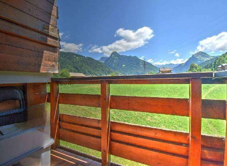 Enjoy breathtaking mountain views from this charming property's wooden balcony.