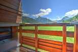 Enjoy breathtaking mountain views from this charming property's wooden balcony.