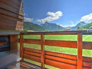 Enjoy breathtaking mountain views from this charming property's wooden balcony.