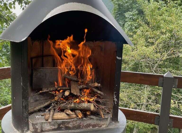 Imagine cozy evenings by this outdoor fireplace, perfect for properties with scenic views and entertainment spaces.