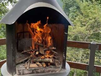 Imagine cozy evenings by this outdoor fireplace, perfect for properties with scenic views and entertainment spaces.