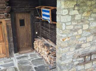 Discover this charming rustic property with a stone facade and inviting wooden door.