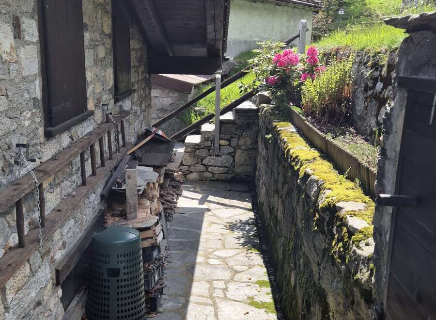 Discover the charm of this stone property featuring a rustic stone facade, complemented by a wooden beam roof.