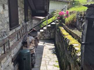 Discover the charm of this stone property featuring a rustic stone facade, complemented by a wooden beam roof.