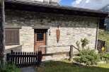 This charming stone cottage exudes rustic elegance with its traditional architecture and inviting entrance.