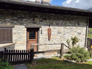 This charming stone cottage exudes rustic elegance with its traditional architecture and inviting entrance.