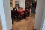 Step into a charming dining area, bathed in warm light and featuring wood-look floors that add a touch of nature.