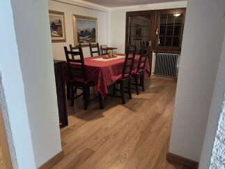 Step into a charming dining area, bathed in warm light and featuring wood-look floors that add a touch of nature.