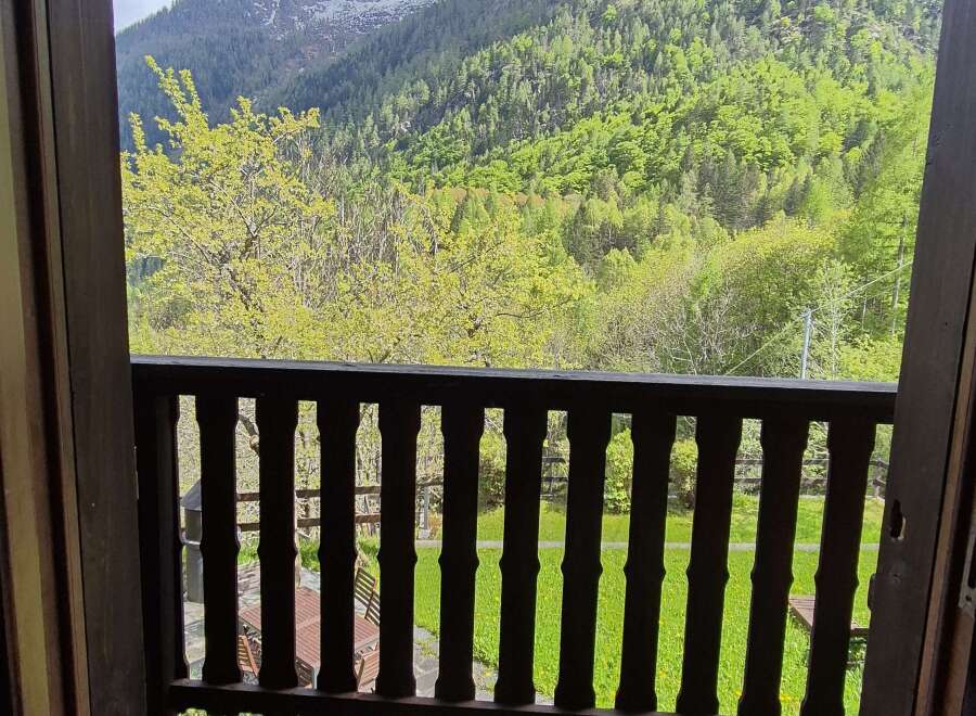 A picturesque balcony view offers stunning mountain scenery, making this property a serene retreat.