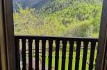 A picturesque balcony view offers stunning mountain scenery, making this property a serene retreat.