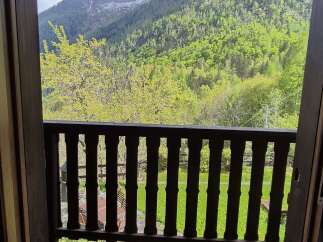 A picturesque balcony view offers stunning mountain scenery, making this property a serene retreat.