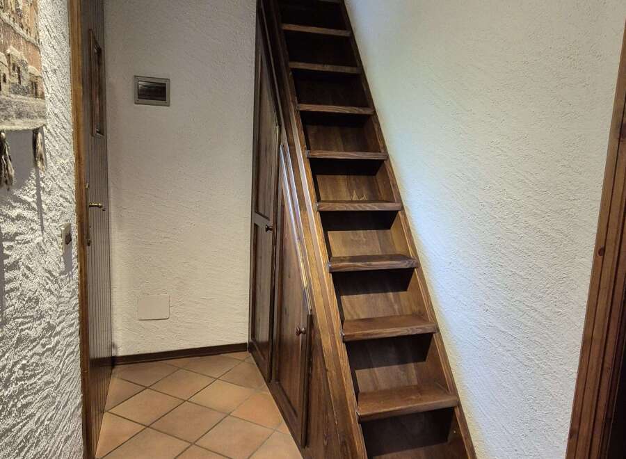 This home features a unique wooden staircase with built-in storage, seamlessly blending functionality with rustic charm.