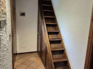 This home features a unique wooden staircase with built-in storage, seamlessly blending functionality with rustic charm.
