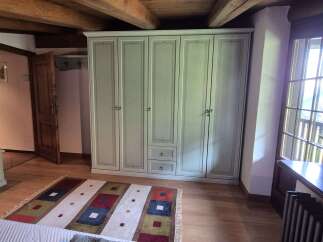 This charming bedroom features a spacious wardrobe, offering ample storage.