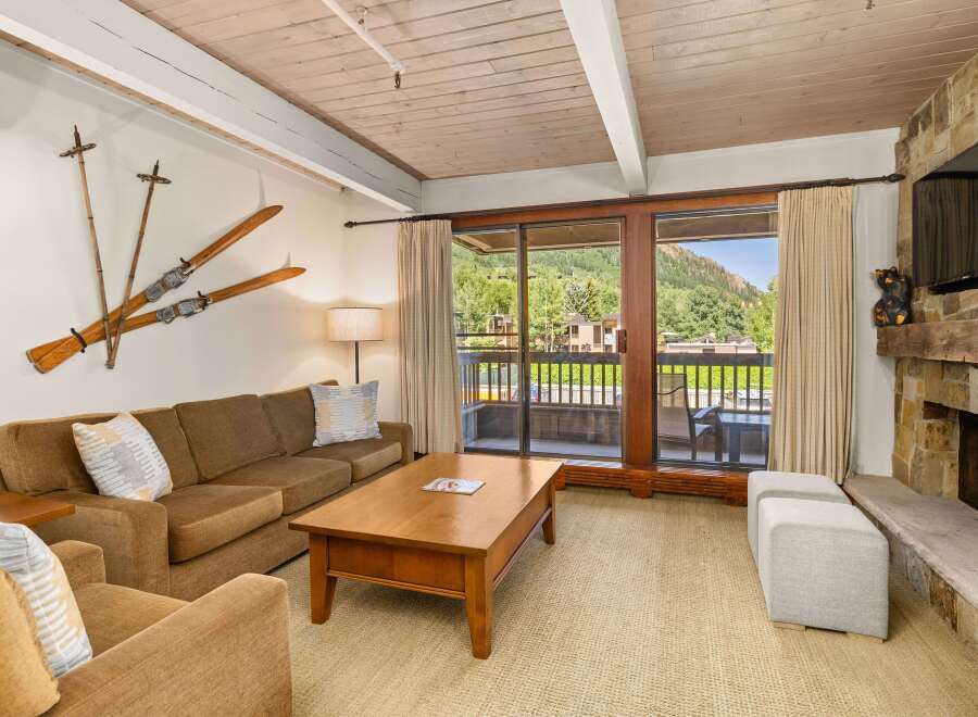 This inviting living room boasts a cozy seating area with a comfortable brown sofa, complemented by unique ski-themed decor.