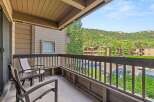 Enjoy the outdoors from this condo's private balcony.