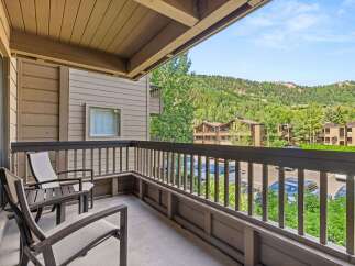 Enjoy the outdoors from this condo's private balcony.