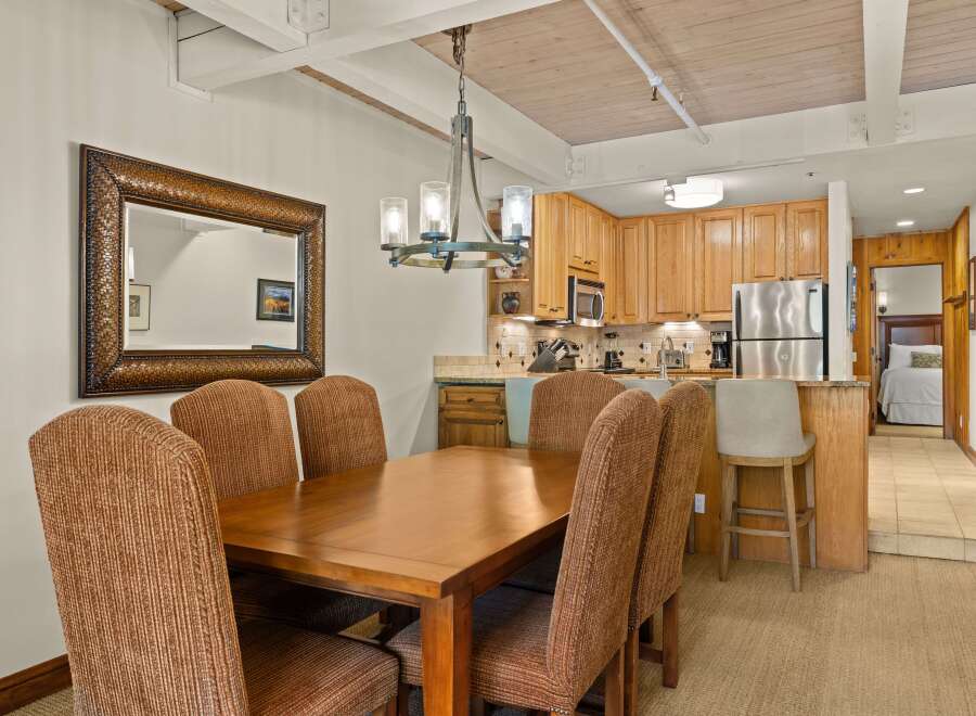 This inviting dining area seamlessly connects to a well-equipped kitchen, creating an ideal space for entertaining.