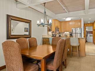 This inviting dining area seamlessly connects to a well-equipped kitchen, creating an ideal space for entertaining.